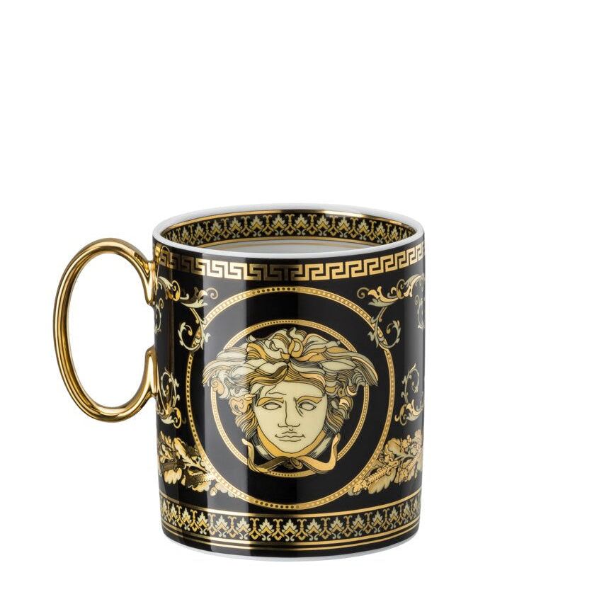 Decorative mug with gold handle and intricate design on a white background