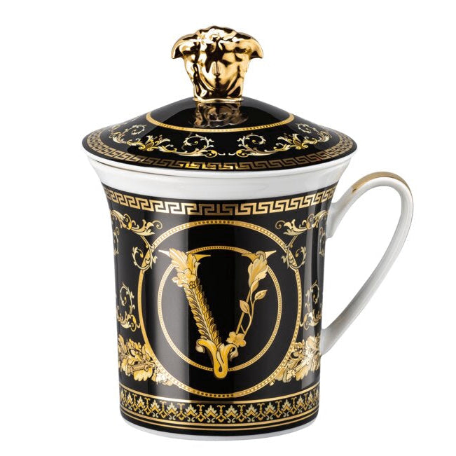 Decorative mug with gold and black design on a white background