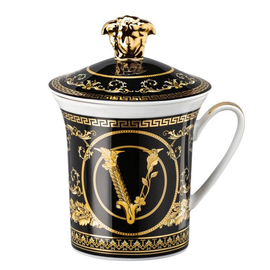 Decorative mug with gold and black design on a white background