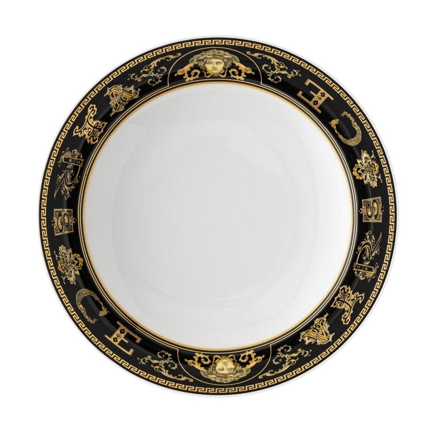 Decorative plate with black and gold rim on a white background