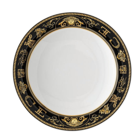 Decorative plate with black and gold rim on a white background