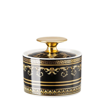 Decorative jar with gold and black design on a white background