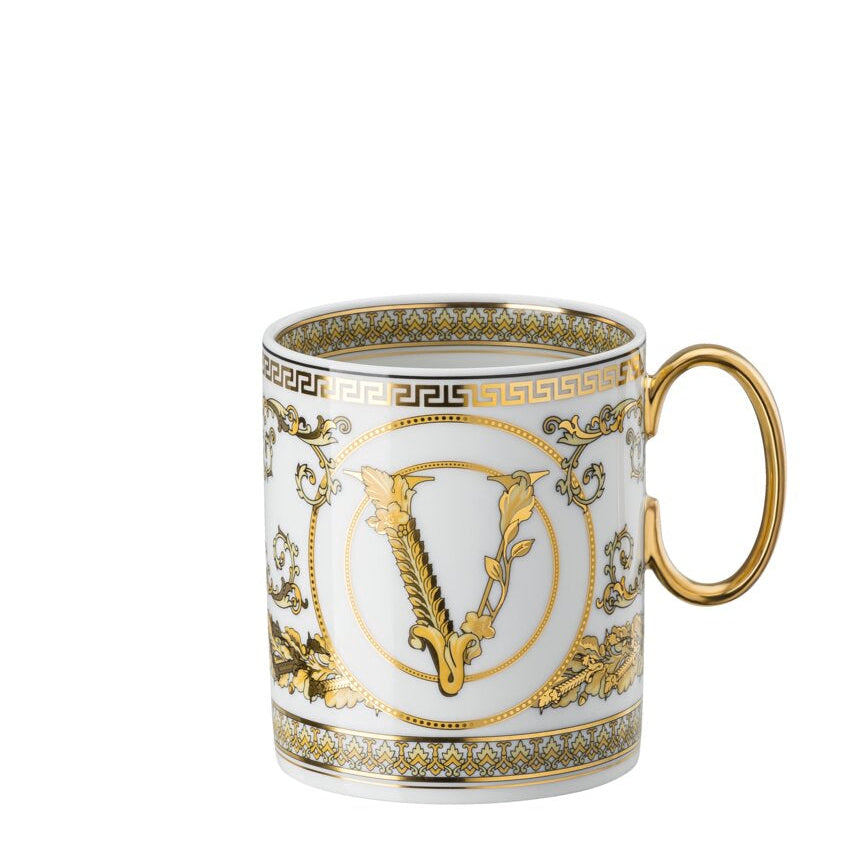 Decorative mug with gold and white design on a white background