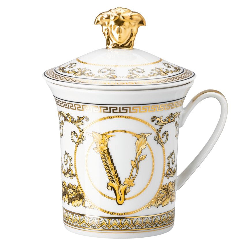 Decorative mug with gold accents and a logo on a white background