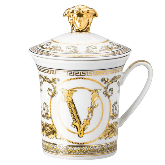 Decorative mug with gold accents and a logo on a white background