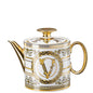 Decorative teapot with gold and white design on a white background