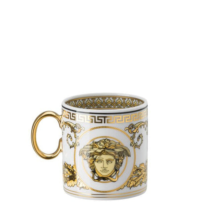 Decorative mug with gold and white design on a white background